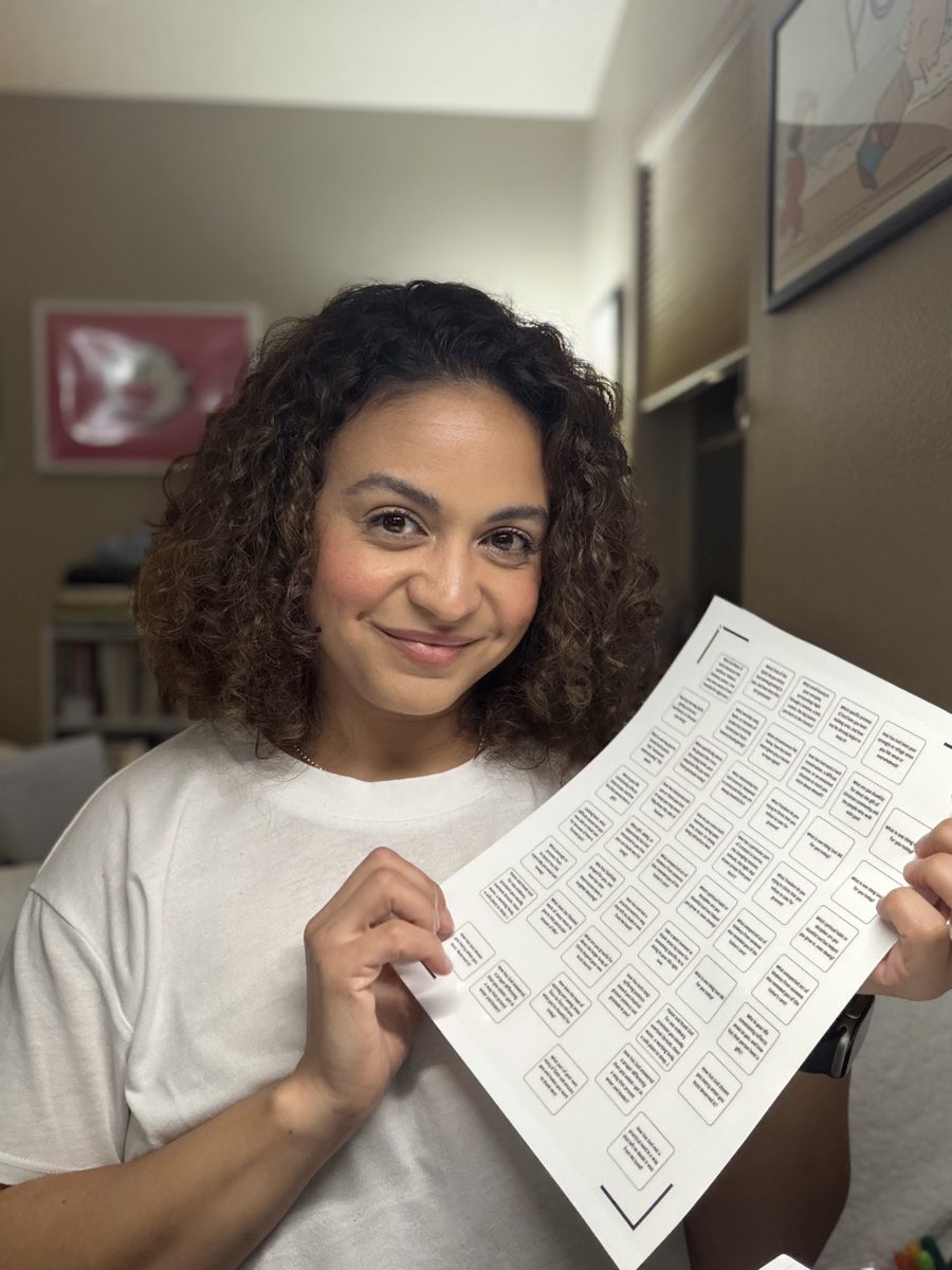Sabrina smiling and holding a sheet of test scripture stickers
